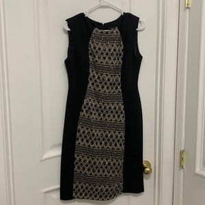 Shiny and beaded black and gold midi dress.